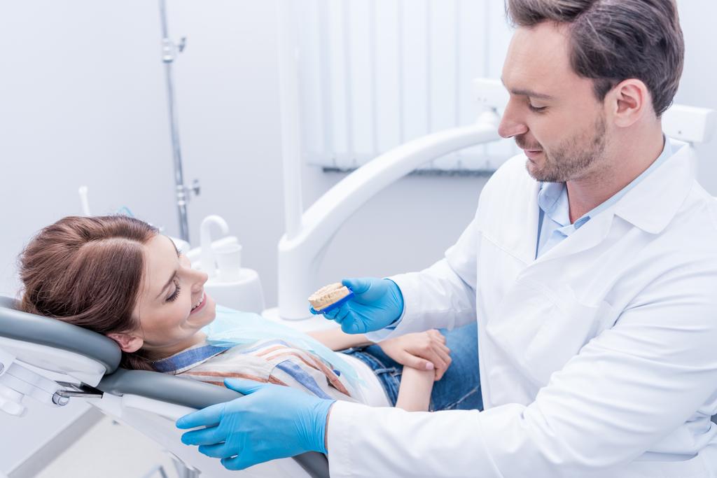 dentist showing dental mold